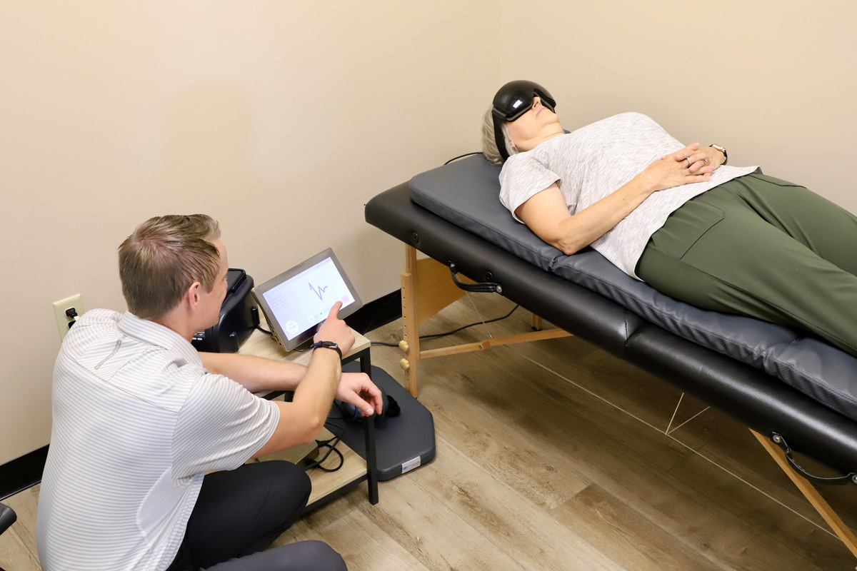 chiropractor monitoring patient undergoing treatment