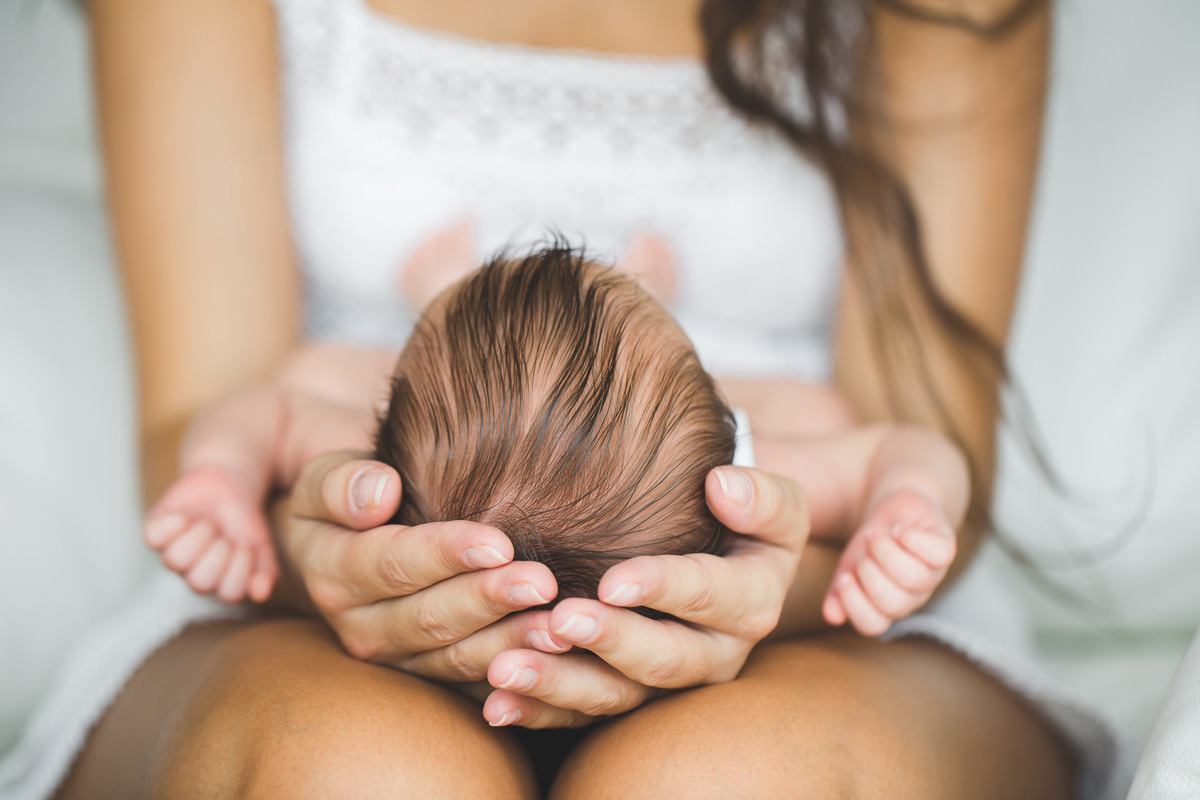 young mother holding newborn baby