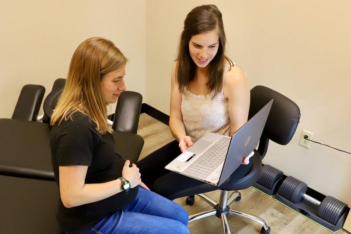 Dr. Rachel performing nutritional consulting with pregnant patient