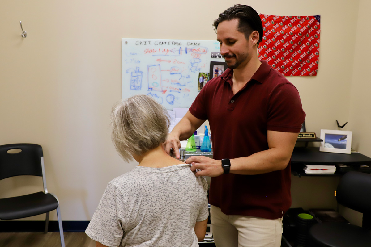 chiropractor treating shoulder pain with FAKTR tool