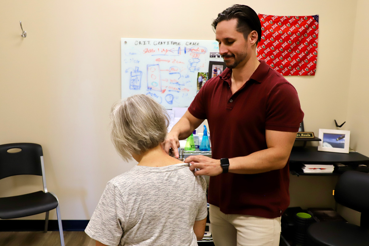 chiropractor providing instrument assisted soft tissue mobilization (IASTM)