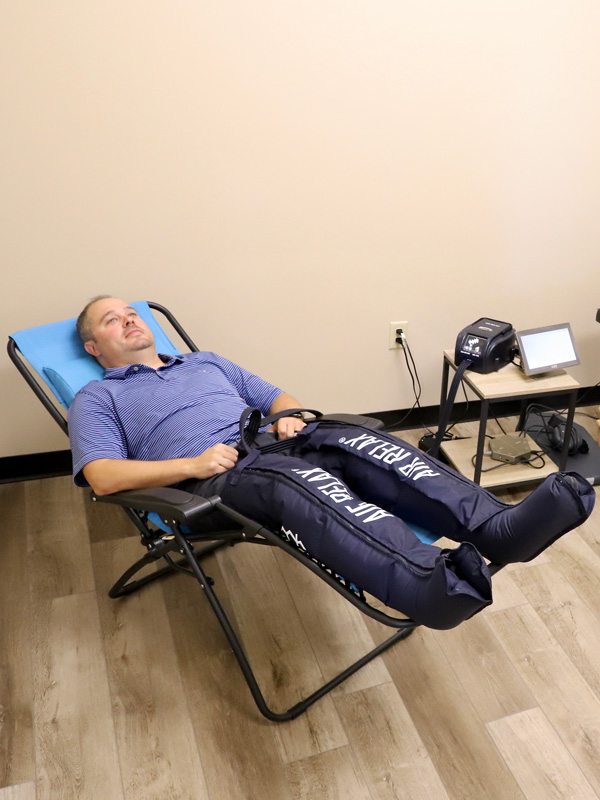 chiropractor monitoring weightlifter rehabilitation
