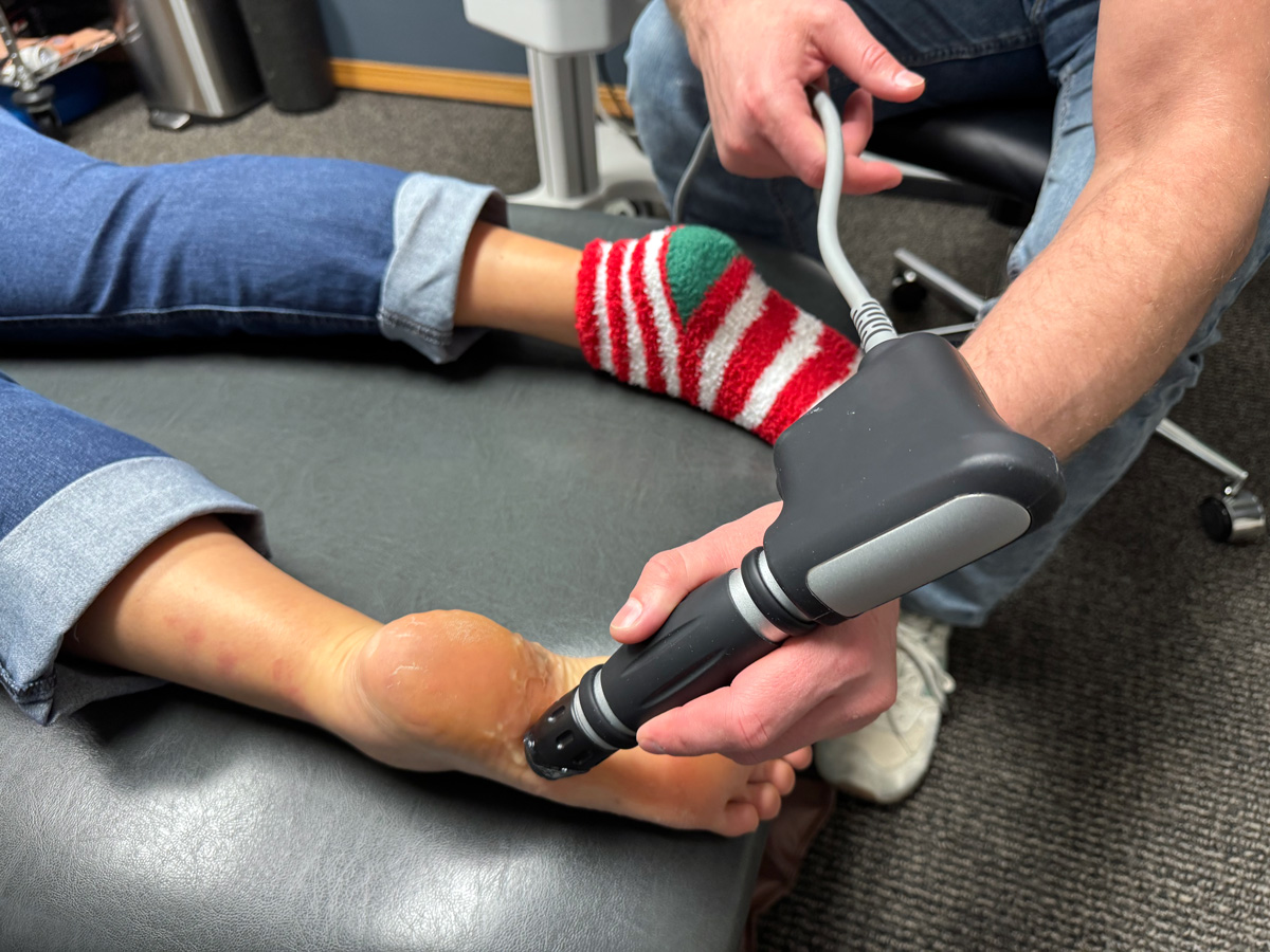 doctor administering shockwave therapy at our wichita, ks clinic