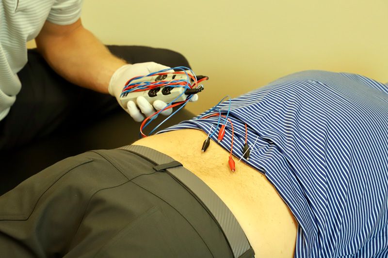 chiropractor administering dry needling therapy