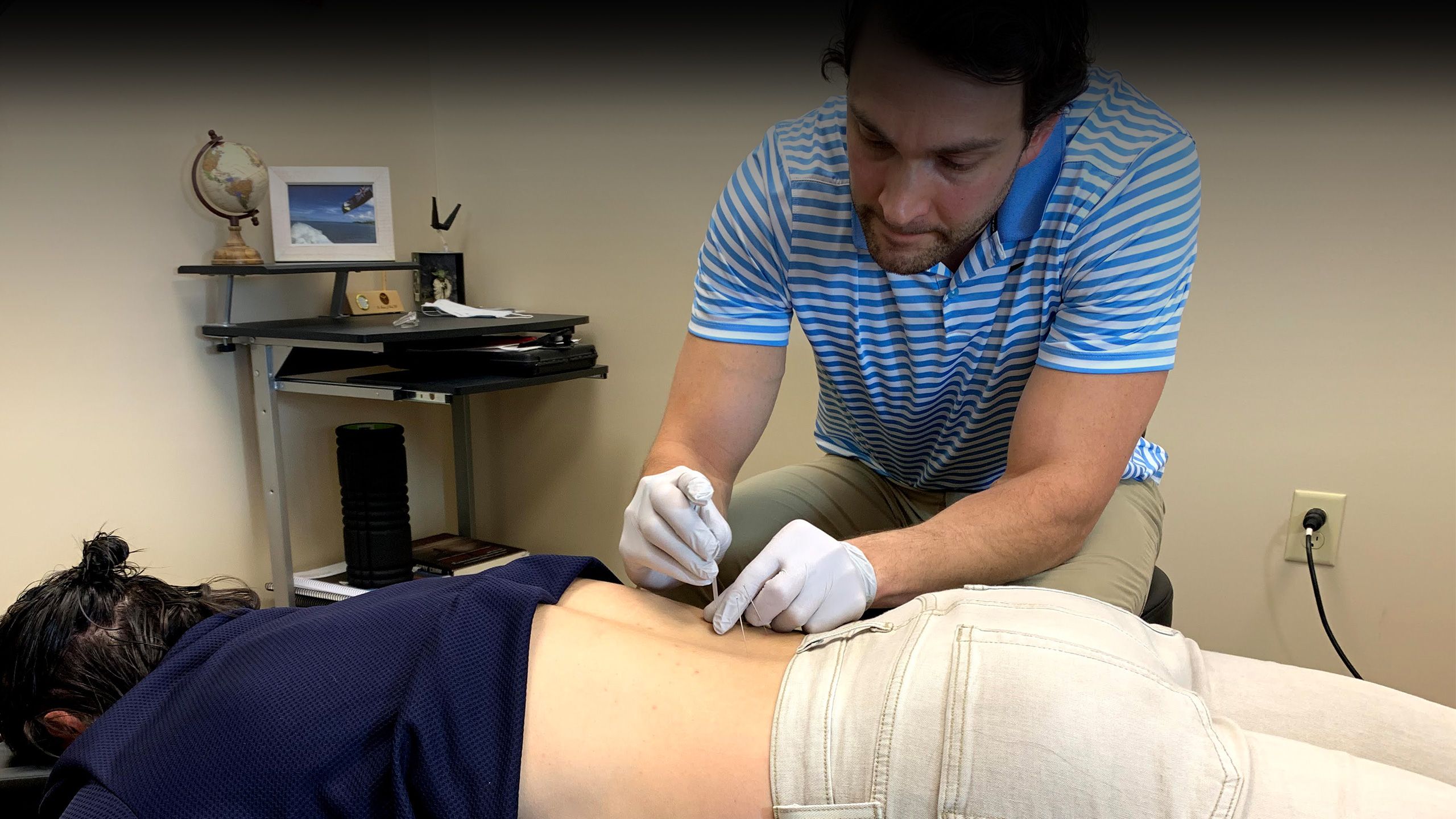 dr tyler panko performing dry needling on patient