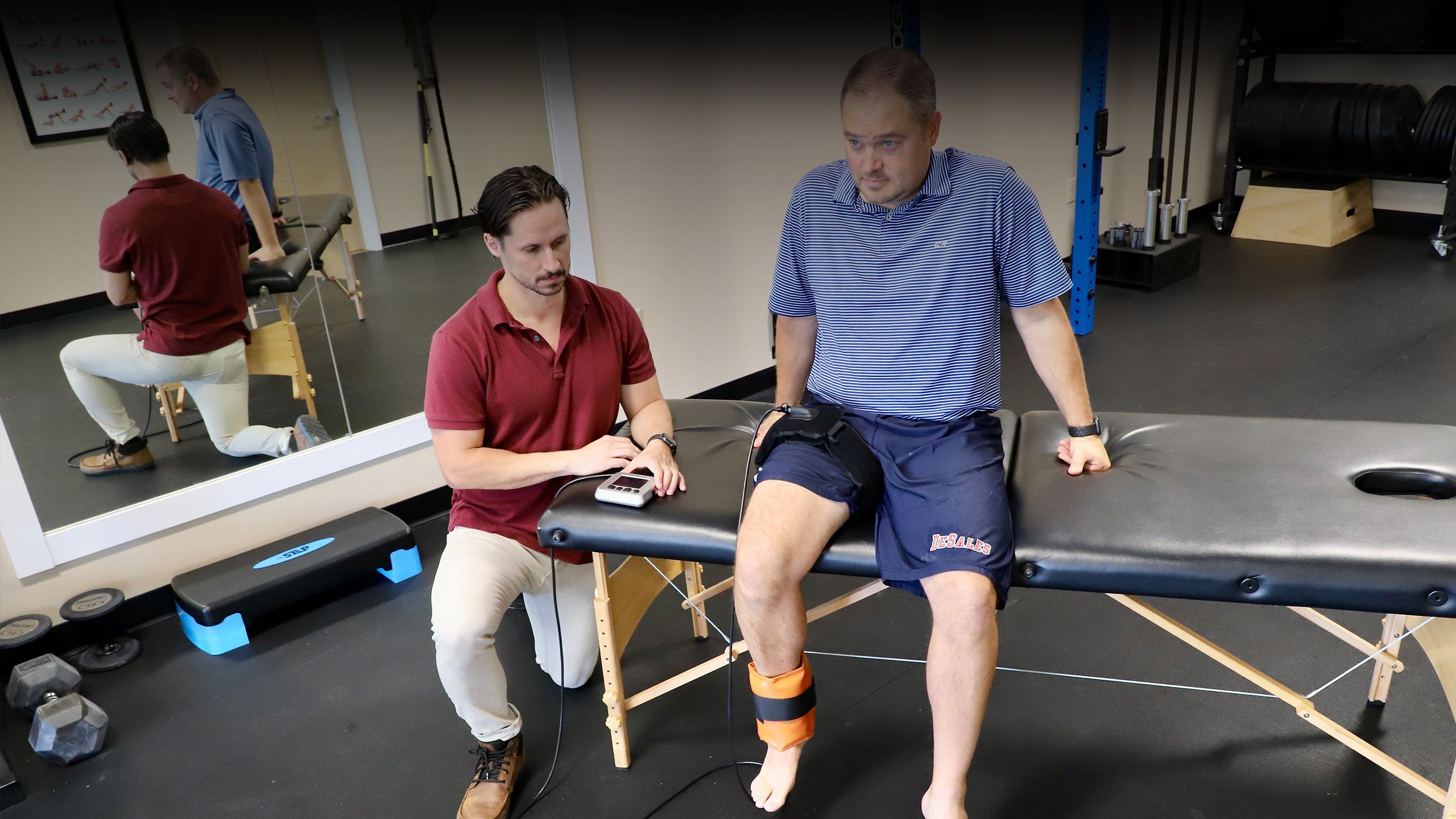 dr sam reals performing blood flow restriction (BFR) with patient