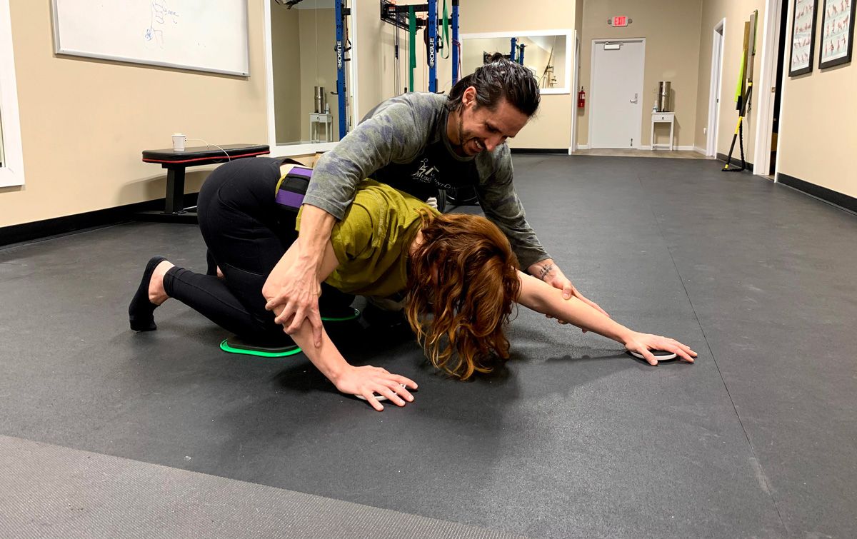 Chiropractor working on physical rehabilitation exercises with patient