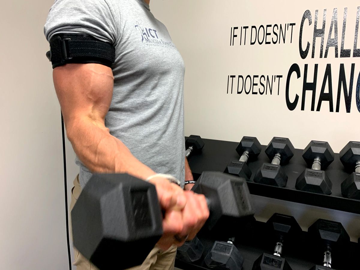 patient lifting weights with blood flow restriction training