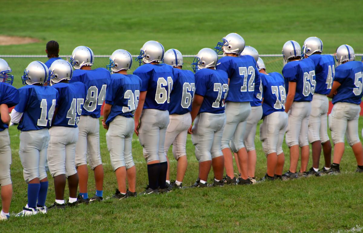football sports team standing on sidelines