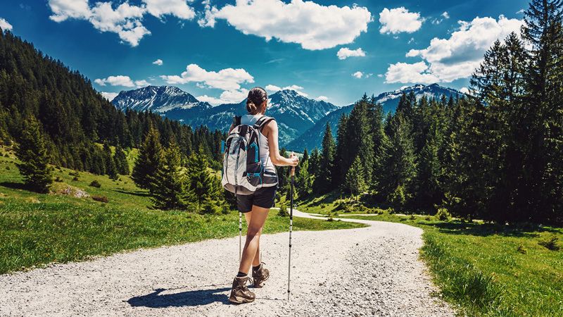 healthy woman hiking a mountain trail